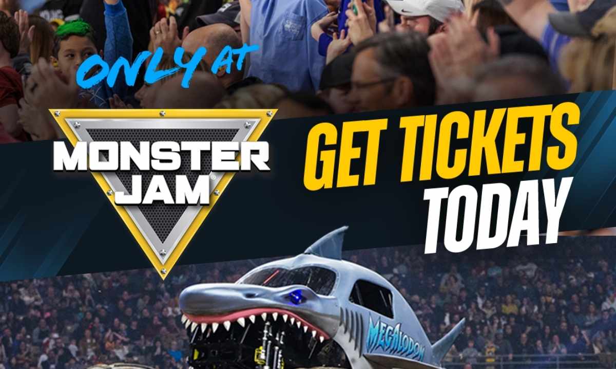 Monster Jam truck Megalodon jumps during a live show at Ford Field in Detroit with fans cheering for the family event.