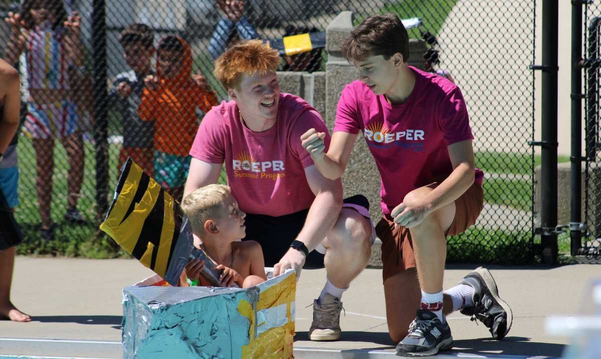 Students take part in Roeper Summer Programs, working together during a hands-on poolside activity at day camp.