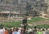 A group of children from a summer camp in Royal Oak watch a bear at the zoo, engaging in an educational wildlife experience with a camp guide.