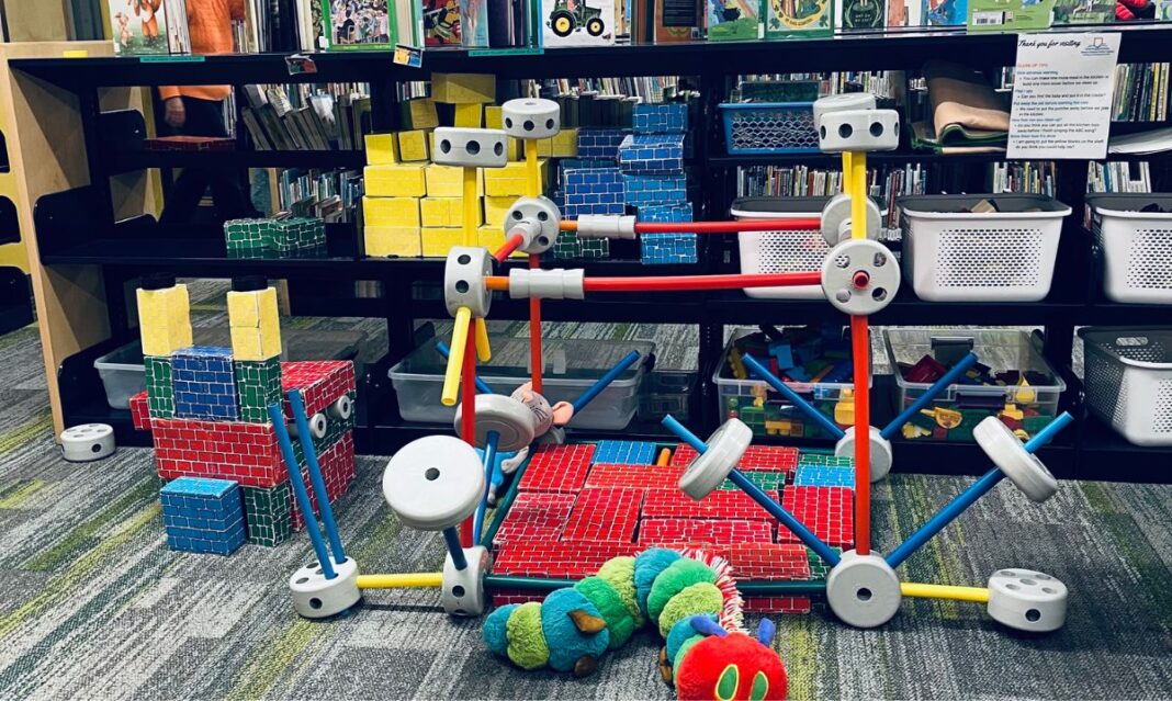 A creative play area at Mount Clemens Public Library designed for kids, featuring colorful building blocks, interactive learning tools, and engaging activities to inspire young minds.