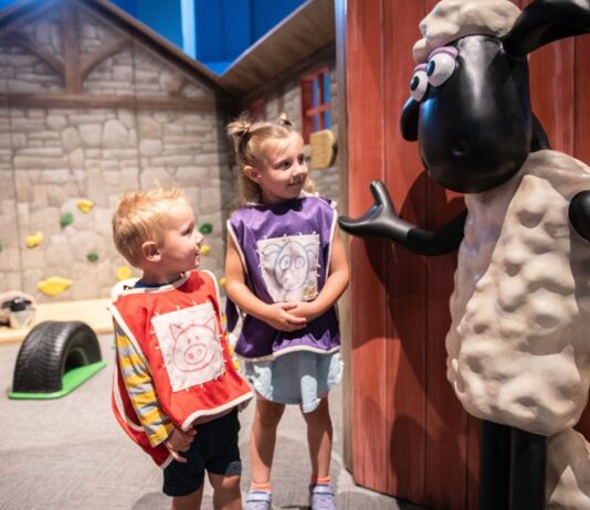 Two young kids interact with a Shaun the Sheep figure at The Henry Ford’s Wallace & Gromit: Get Cracking! exhibit, part of the new spring exhibits in metro Detroit.
