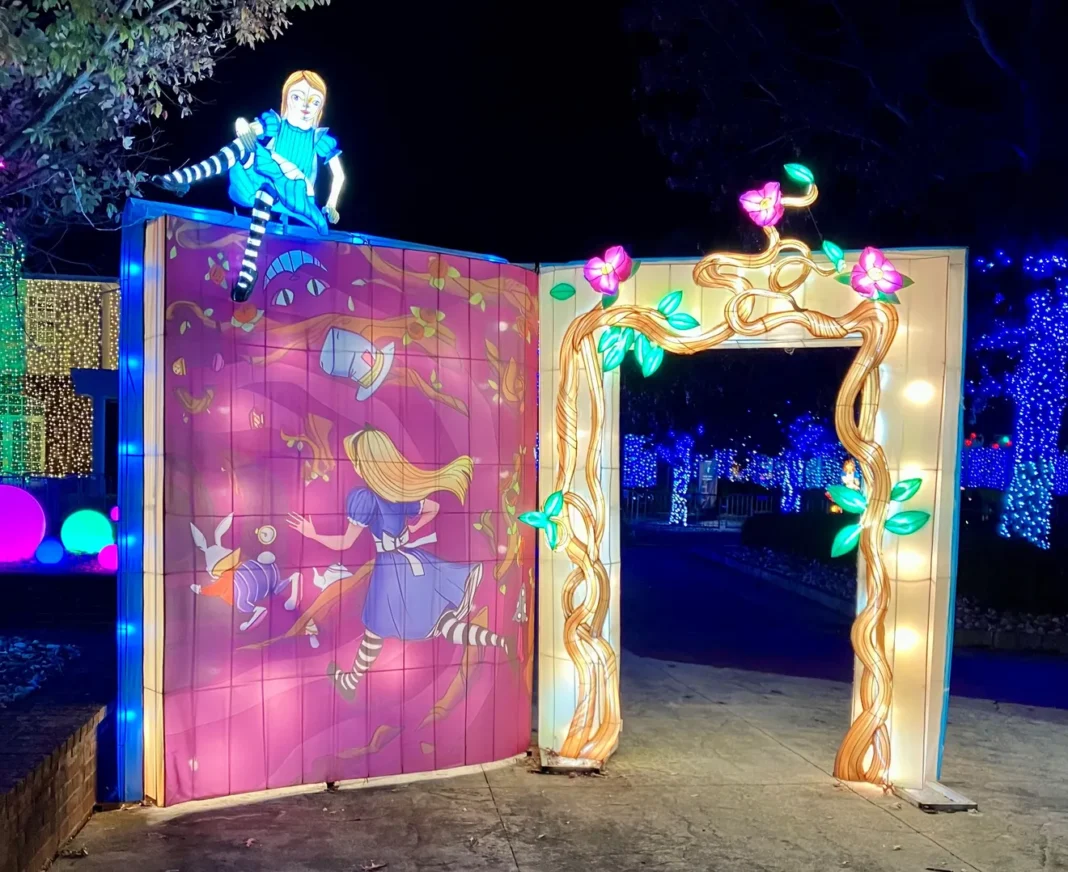 Alice in Wonderland-themed illuminated entrance at Canterbury Village Wonderland Lantern Stroll, featuring vibrant lights and whimsical characters