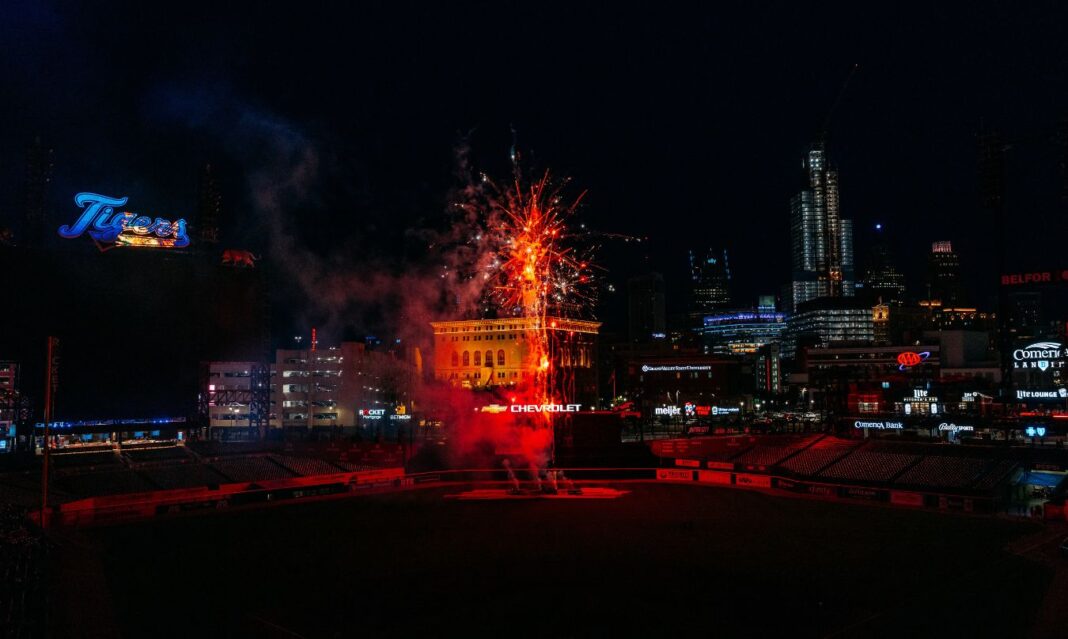 Fireworks at Comerica Park in downtown Detroit after a Detroit Tigers game, lighting up the skyline with vibrant red bursts.