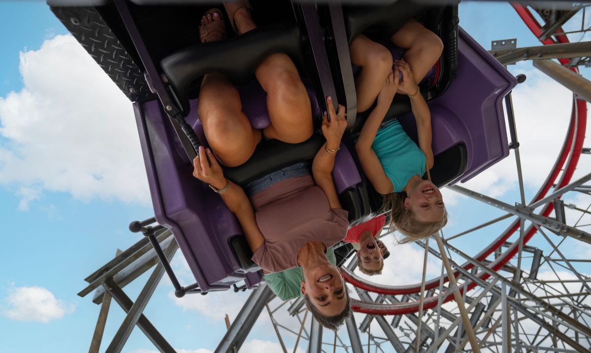 Family laughing and riding an upside-down roller coaster during a thrilling Louisville Kentucky family adventure.