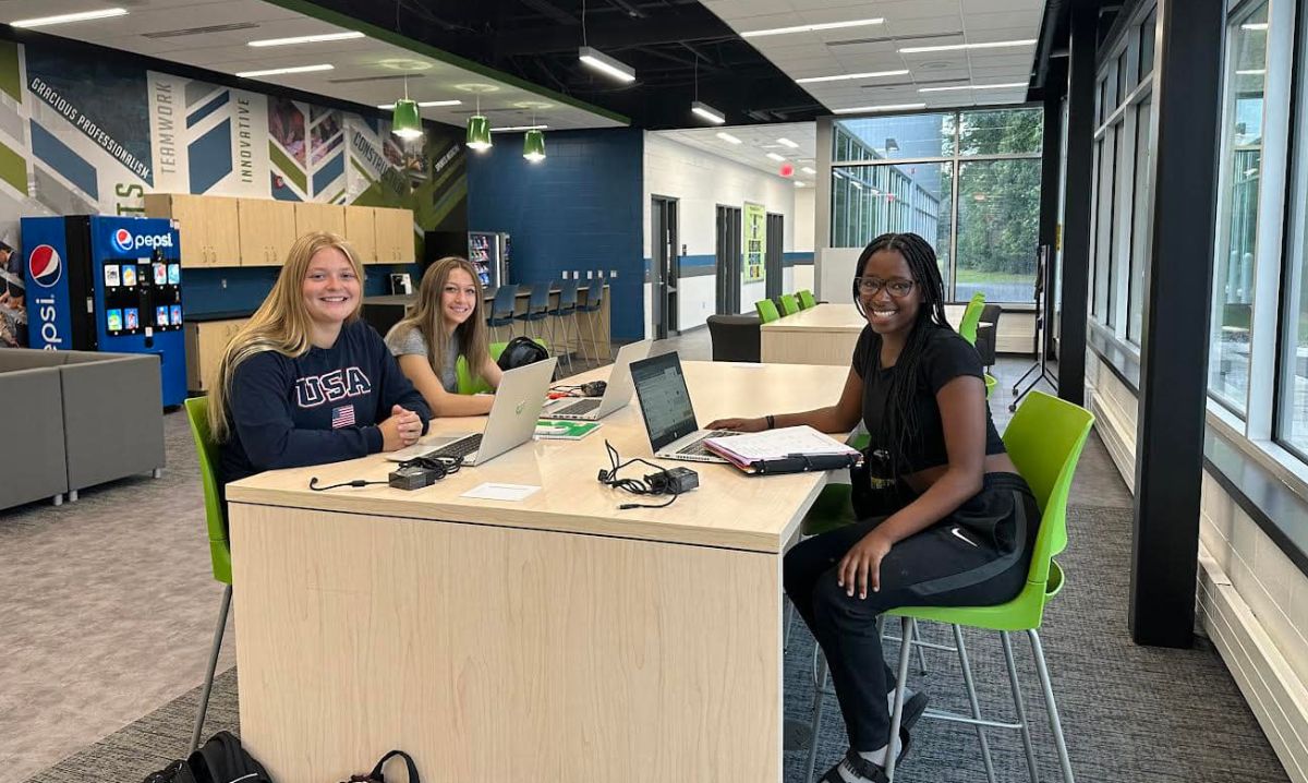 High school students collaborating in a modern Livonia Public Schools common area, representing one of the best schools in metro Detroit.