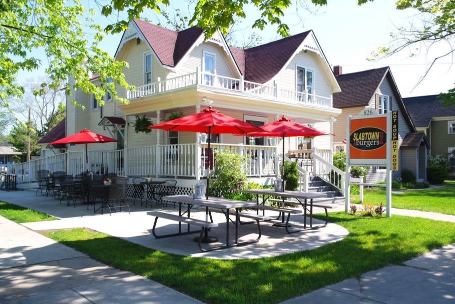 Slabtown Cafe and Burgers in Traverse City with outdoor seating and red umbrellas, a popular family-friendly restaurant serving burgers, hot dogs, and more.