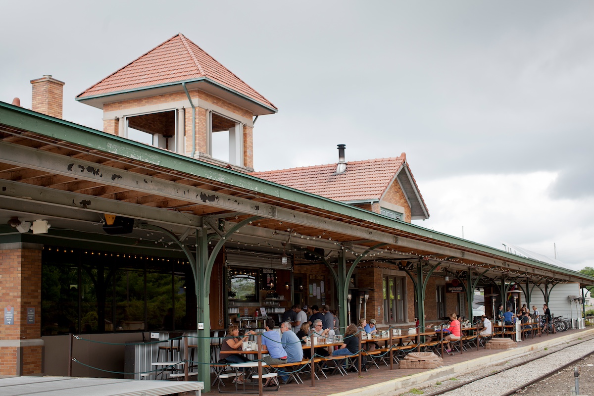 Families dining outdoors at The Filling Station in Traverse City, one of the best family-friendly restaurants in the area.