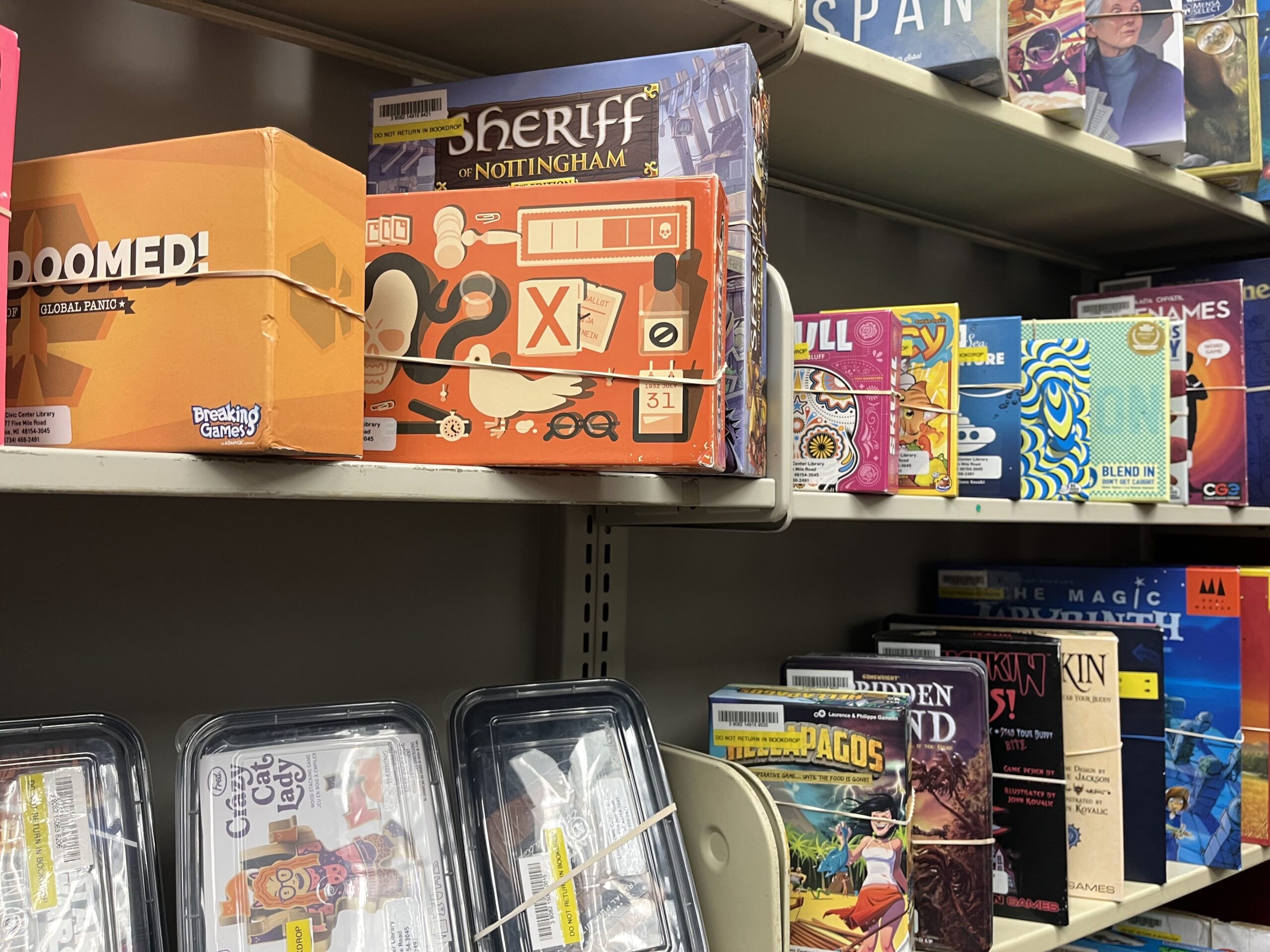 Board games available to borrow on the shelves of the Library of Things at the Livonia Public Library.