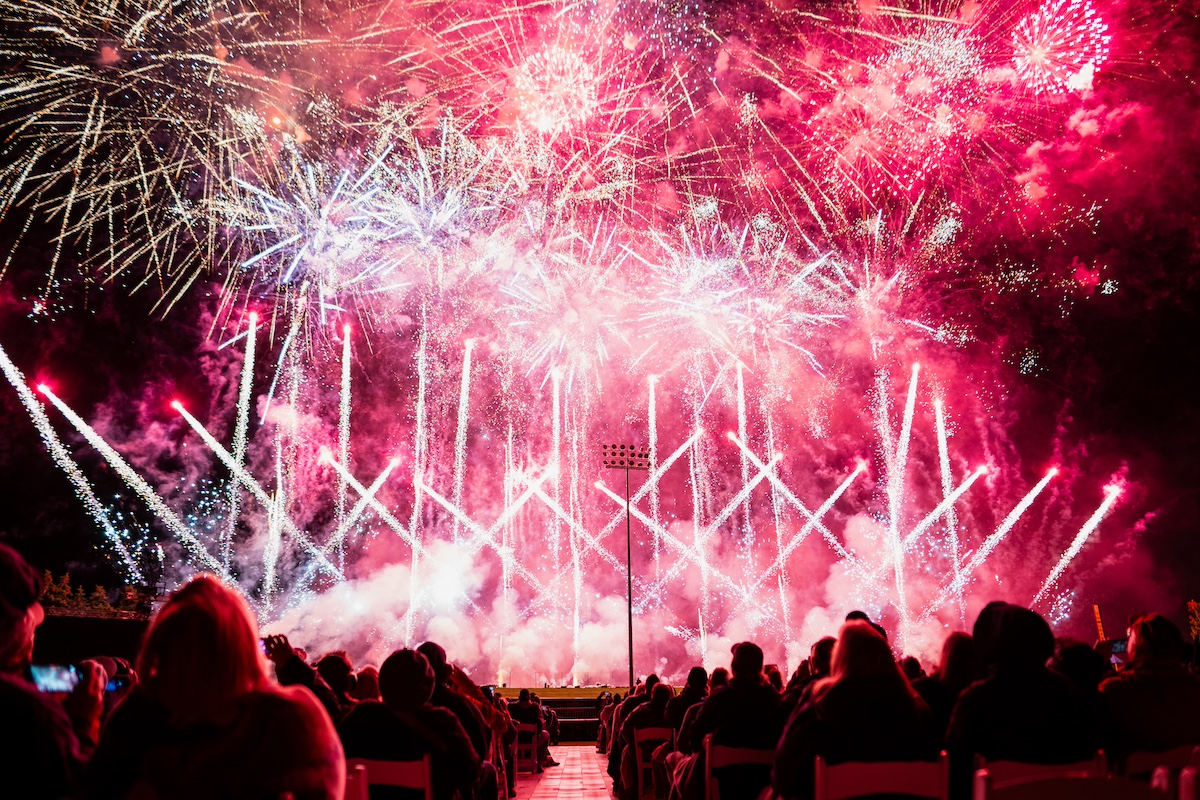 Families gathered at night to watch a dazzling fireworks display during a summer event in Traverse City, part of the International Fireworks Championship celebration.