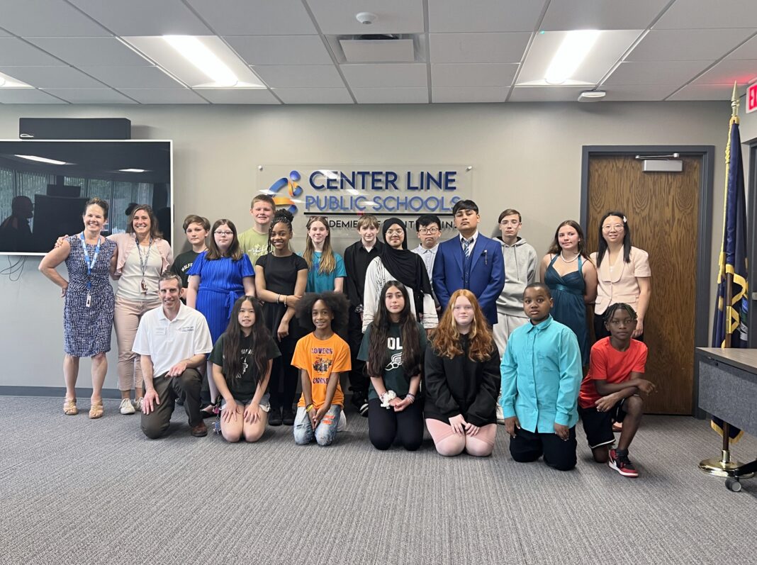 Academy Explorer 6 students and staff from Center Line Public Schools pose for a group photo during a recognition event.