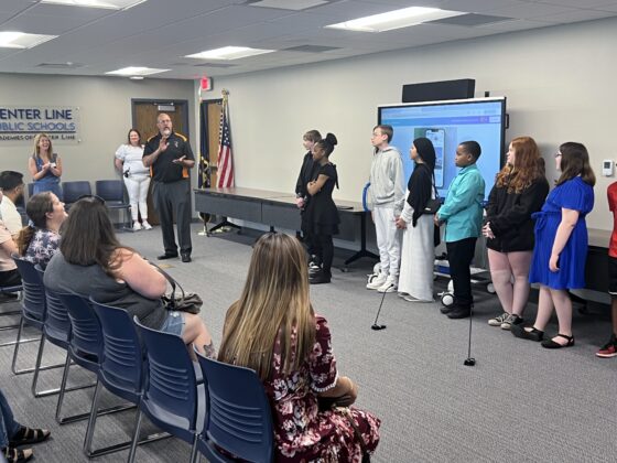 Academy Explorer 6 students line up to present their final projects at Center Line Public Schools as parents and staff look on during the culminating event.