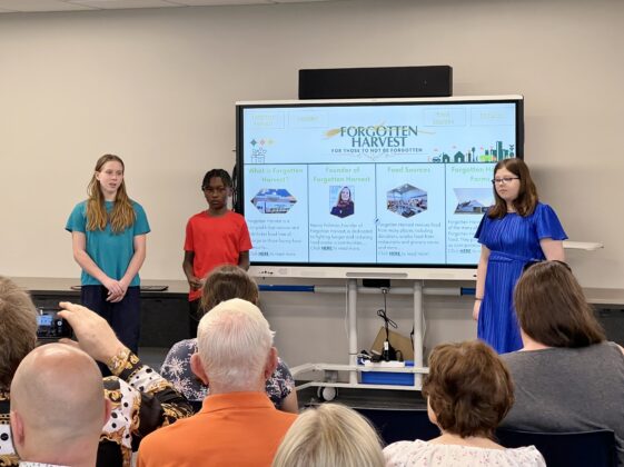 Academy Explorer 6 students present their research on Forgotten Harvest, highlighting the nonprofit&rsquo;s mission to fight food insecurity through community partnerships and food rescue efforts.