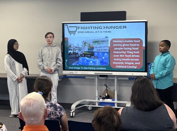 Academy Explorer 6 students present on Gleaners Mobile Food Pantry, highlighting efforts to combat food insecurity in Macomb, Wayne, and Oakland counties through monthly food drives.