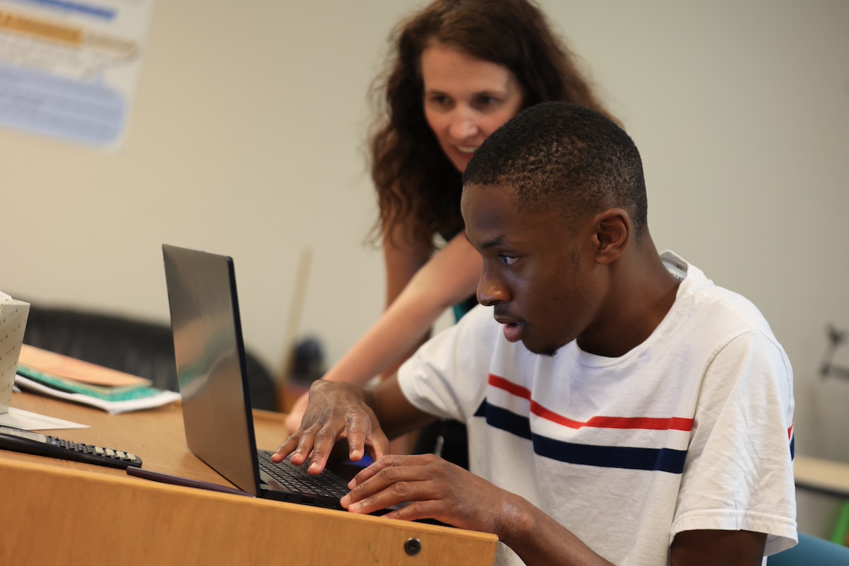 Student at Aim High School receiving individualized support on a laptop, highlighting the school’s commitment to personalized special education accommodations.