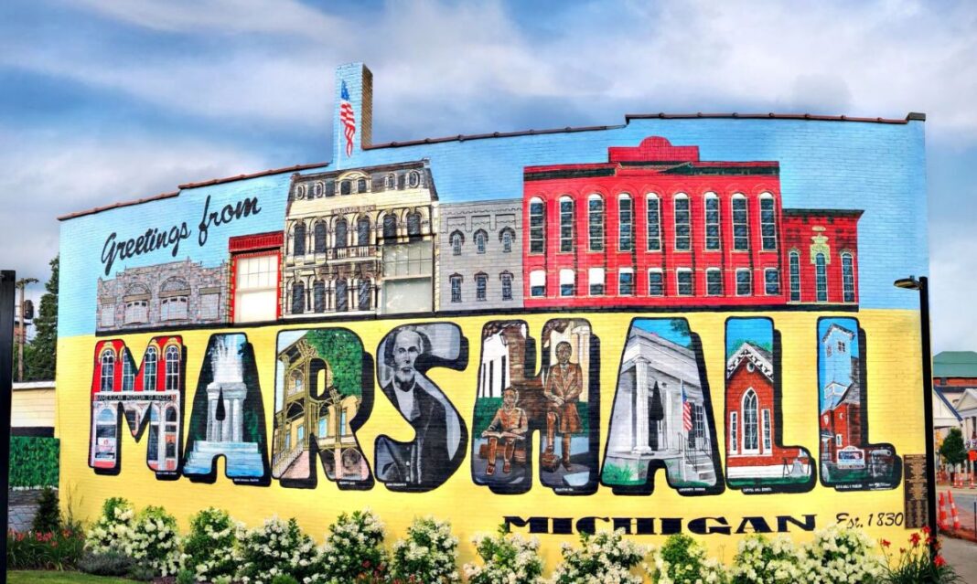 Colorful mural on a downtown building in the city of Marshall, Michigan, showcasing local landmarks and making it a fun photo stop for families exploring the area.