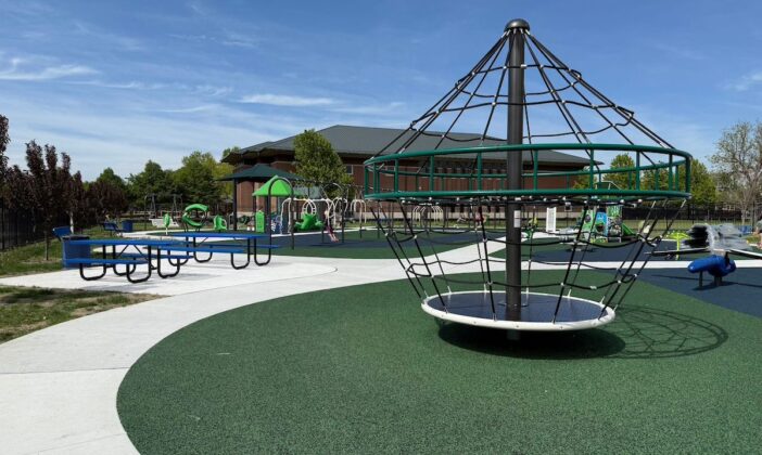Clinton Township inclusive playground featuring accessible equipment, picnic tables, and a modern design that welcomes kids of all abilities.
