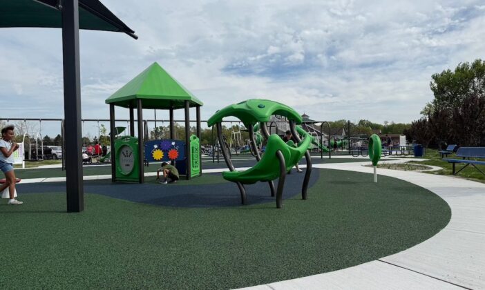 Children play at Clinton Township inclusive playground, enjoying sensory-friendly equipment, shaded structures, and accessible features designed for kids of all abilities.