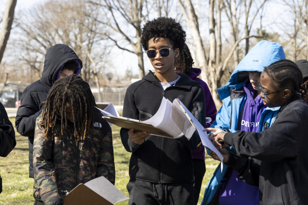 Middle school students from Detroit Achievement Academy collaborating outdoors on a student-designed park project