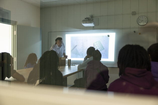 Detroit Achievement Academy students viewing a classroom presentation of their student-designed park project