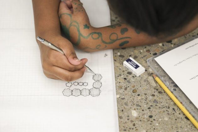Detroit Achievement Academy student sketching landscape elements for a student-designed park project