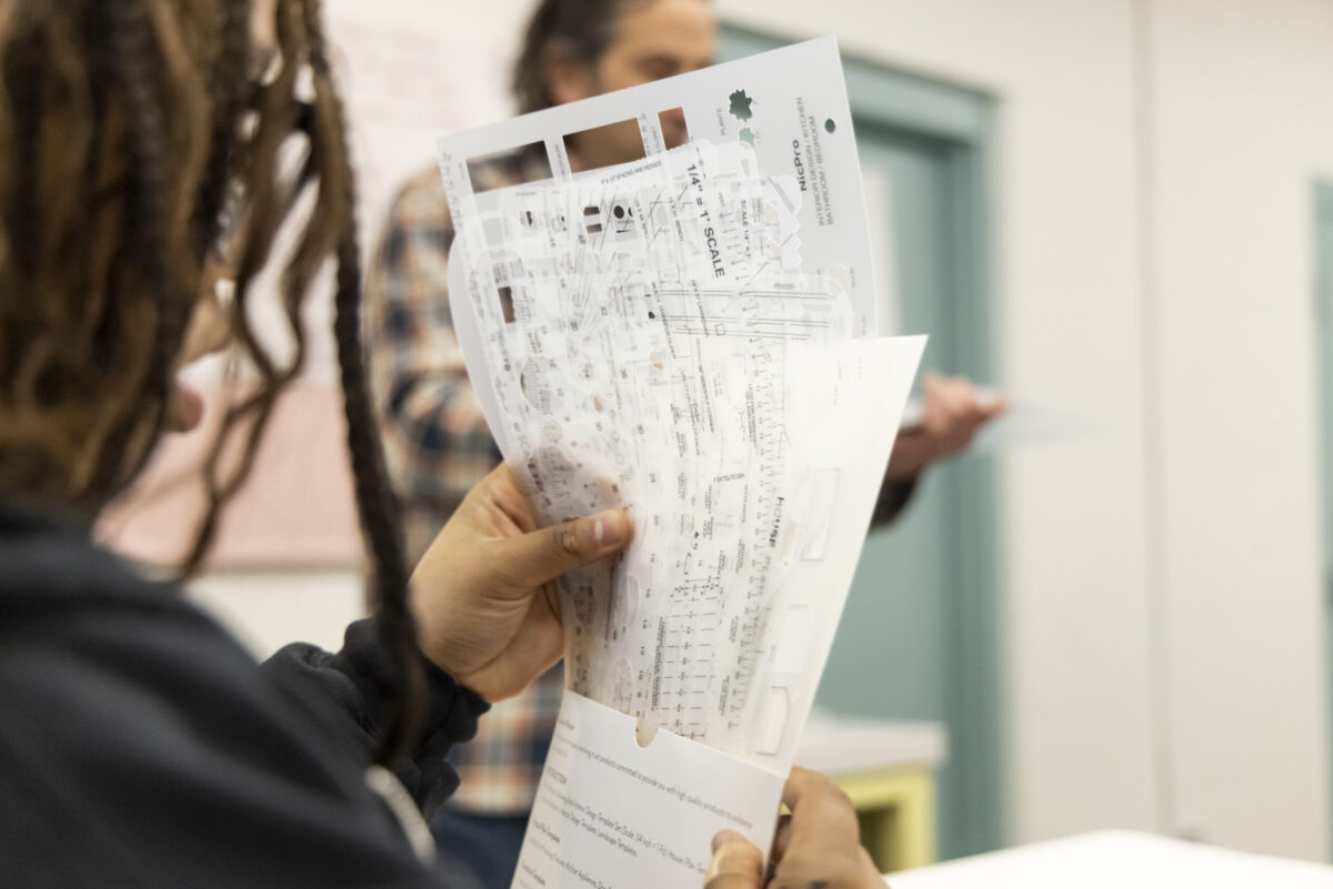 Detroit Achievement Academy student examining planning tools for a student-designed park project