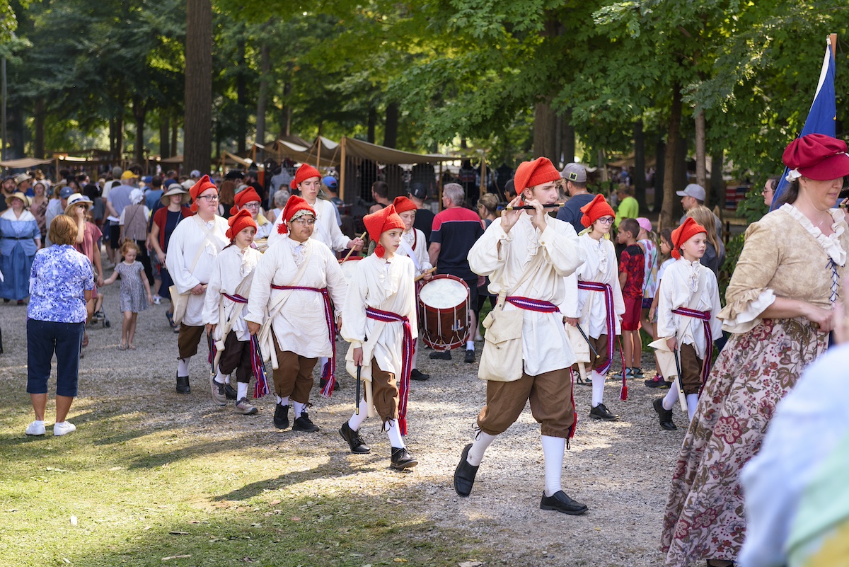 Costumed parade participants marching through the crowd at the Johnny Appleseed Festival, one of the top summer festivals in Fort Wayne, Indiana