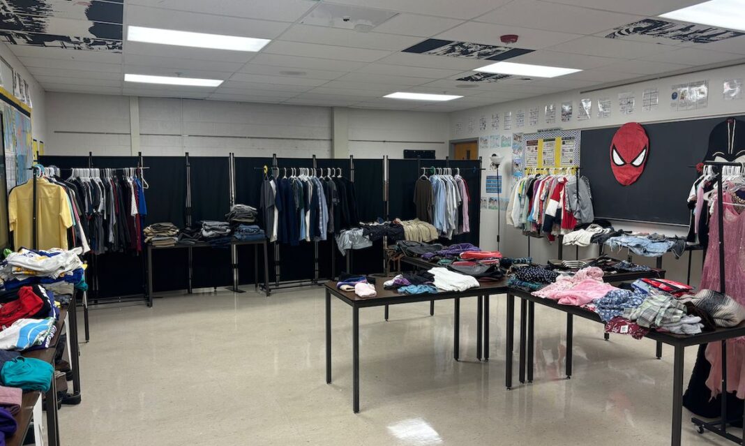 Clothing neatly displayed on racks and tables inside the thrift store at Fraser High School, offering affordable fashion options for students and families.