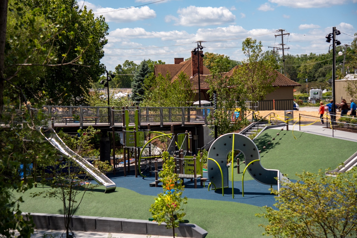 PNC Playground at Promenade Park in Fort Wayne, Indiana, featuring modern climbing structures, slides, and green play surfaces designed for children.