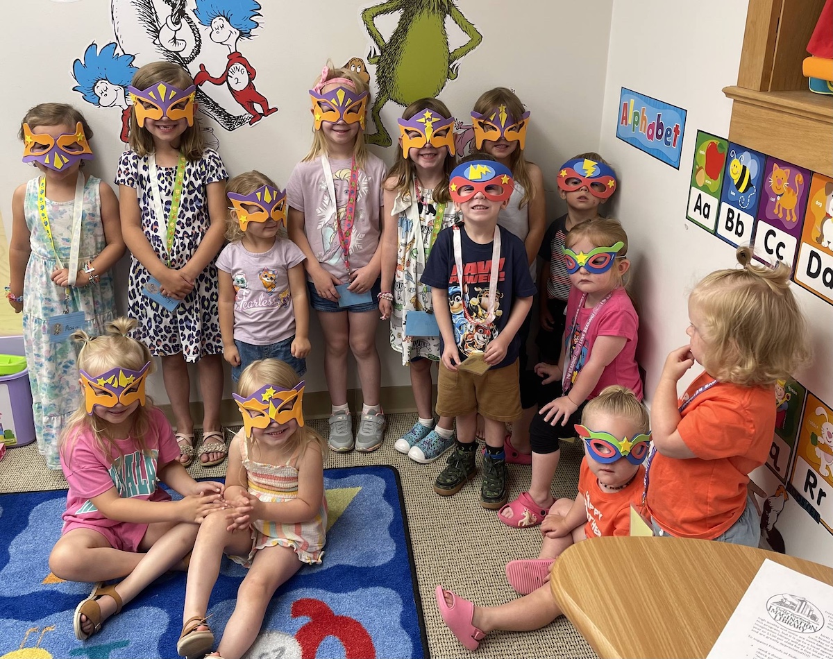 Preschoolers wearing superhero masks at a literacy event at Armada Library — one of the best libraries in Macomb County for fun and engaging early reading programs.
