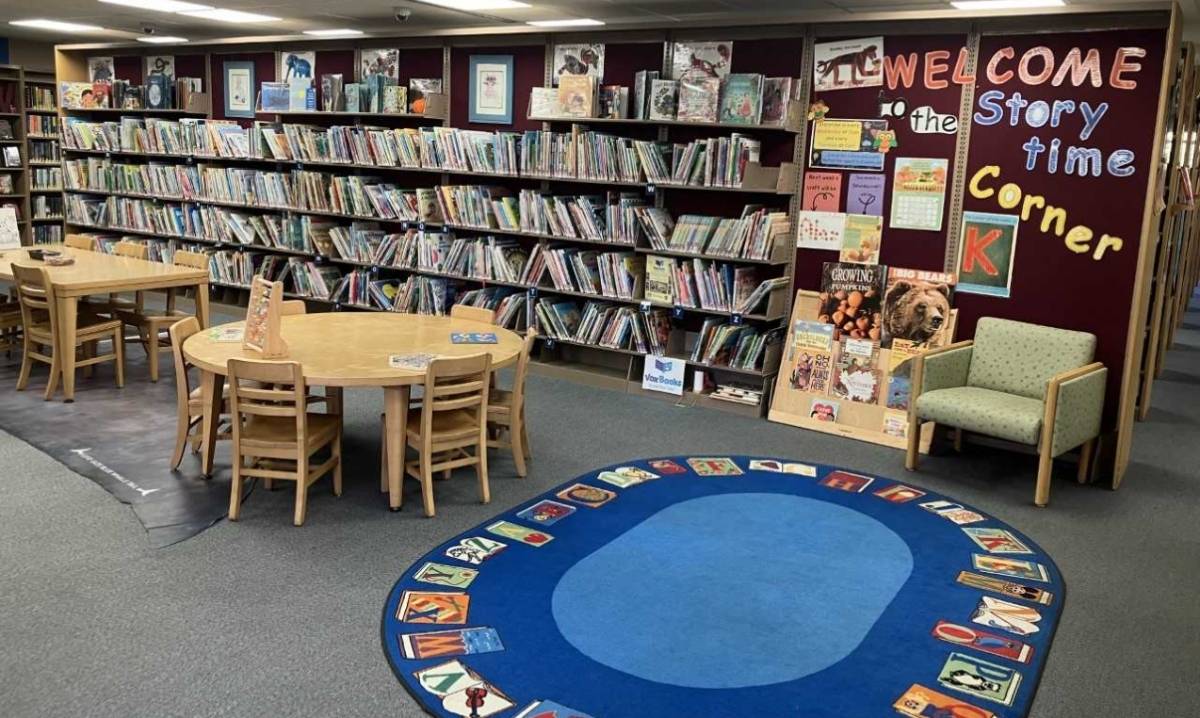 Children’s storytime area at Center Line Public Library in Macomb County, featuring bookshelves, reading tables, and a colorful rug — one of the best libraries in Macomb County for kids.
