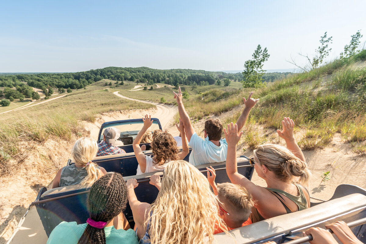 Families enjoying a thrilling dune ride adventure at Saugatuck Dunes, one of the best things to do in Saugatuck Michigan with kids.