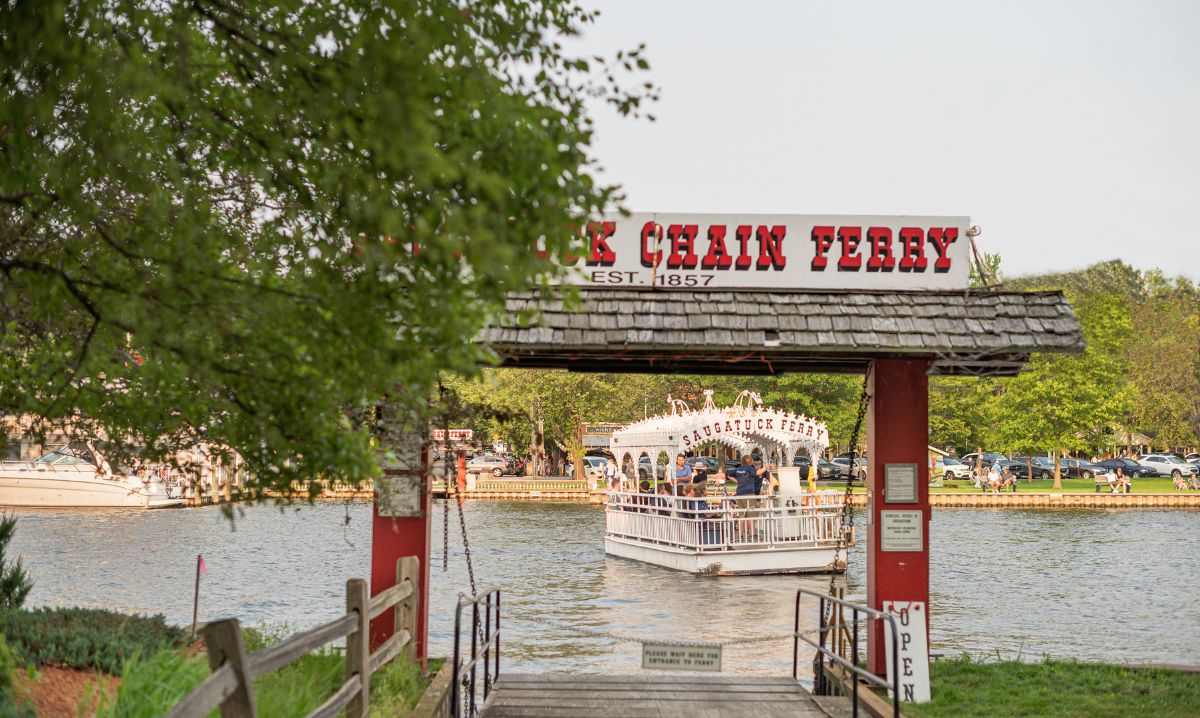Historic Saugatuck Chain Ferry transporting visitors across the Kalamazoo River on the way to Oval Beach at Saugatuck State Park.