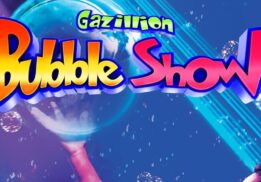 Gazillion Bubble Show at Whiting Auditorium on May 2, featuring a performer holding a giant bubble surrounded by smaller bubbles and colorful lights.