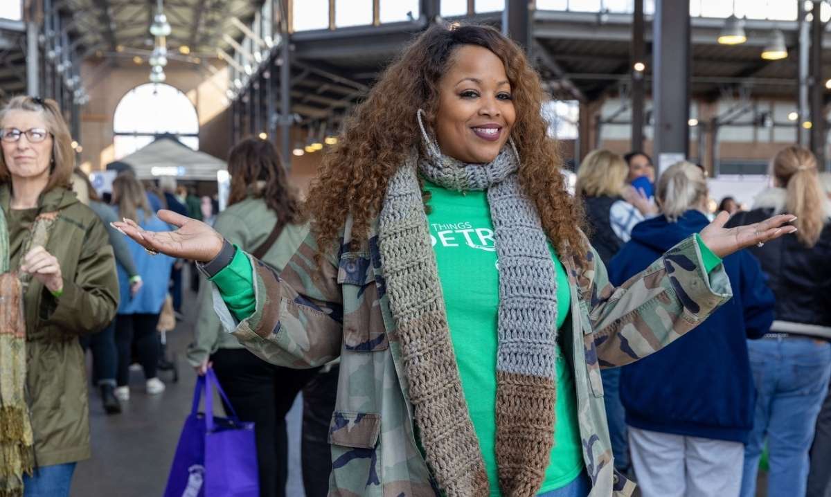 Visitor enjoys All Things Detroit Holiday Shopping Experience at Eastern Market with vendors food trucks and festive activities