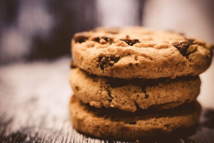 Stack of chocolate chip cookies representing the Royal Oak Cookie Crawl where families collect handcrafted cookies from local shops