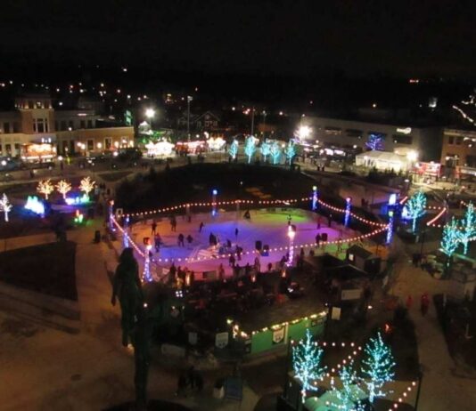 Families enjoy ice skating and holiday lights during the Royal Oak Holidays Lighting of the Park at Centennial Commons with Santa and live music.