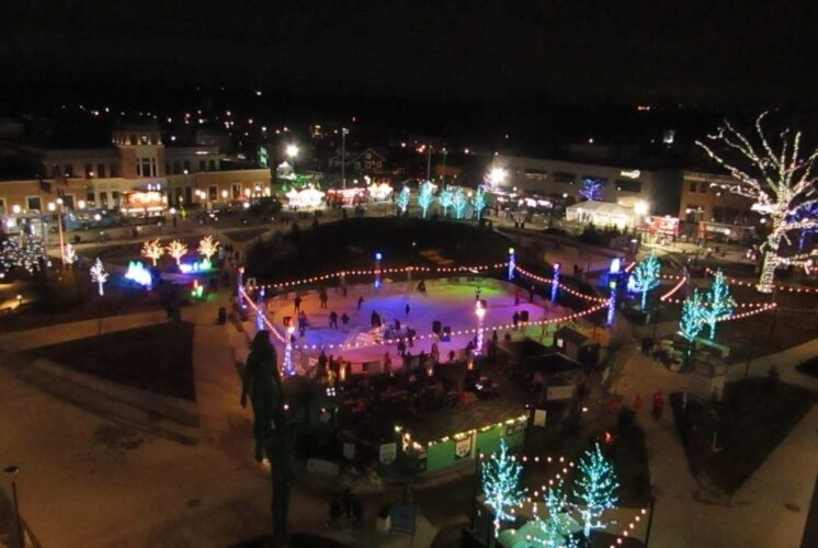 Families enjoy ice skating and holiday lights during the Royal Oak Holidays Lighting of the Park at Centennial Commons with Santa and live music.