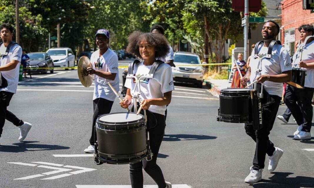 Marching band performs along Woodward Avenue during the 99th America’s Thanksgiving Parade in Detroit 2025, celebrating Thanksgiving morning.