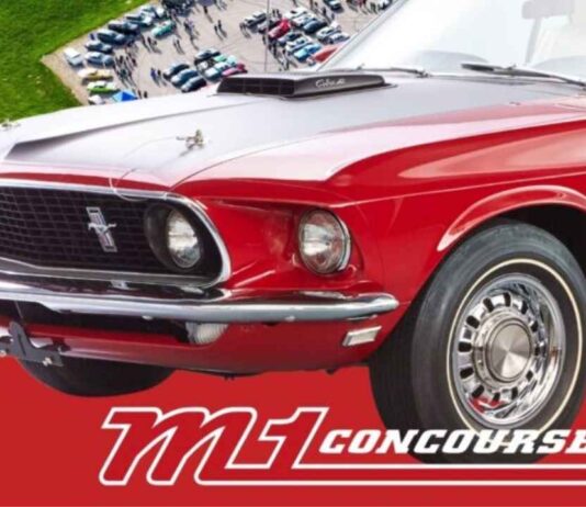 A classic red Mustang on display at M1 Concourse in Pontiac Michigan during the Cars and Coffee event for car enthusiasts.