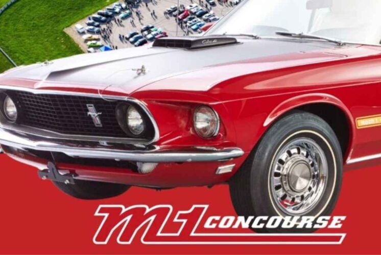 A classic red Mustang on display at M1 Concourse in Pontiac Michigan during the Cars and Coffee event for car enthusiasts.