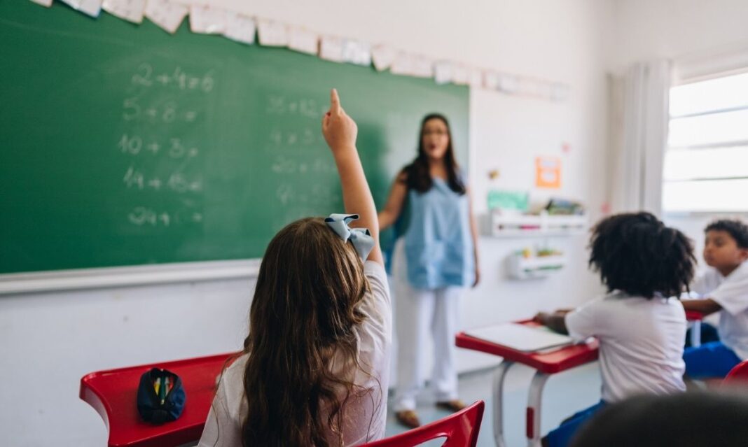 Student raising hand in a classroom at DeKeyser Elementary in Sterling Heights after reopening with new upgrades and safety improvements.