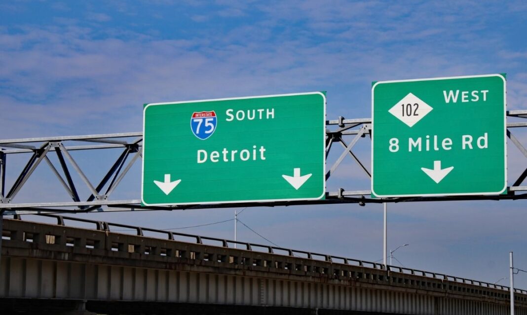 Highway signs for Detroit and 8 Mile Road along I-75 showing the route that inspired Eminem’s 8 Mile and marks Detroit’s northern boundary.