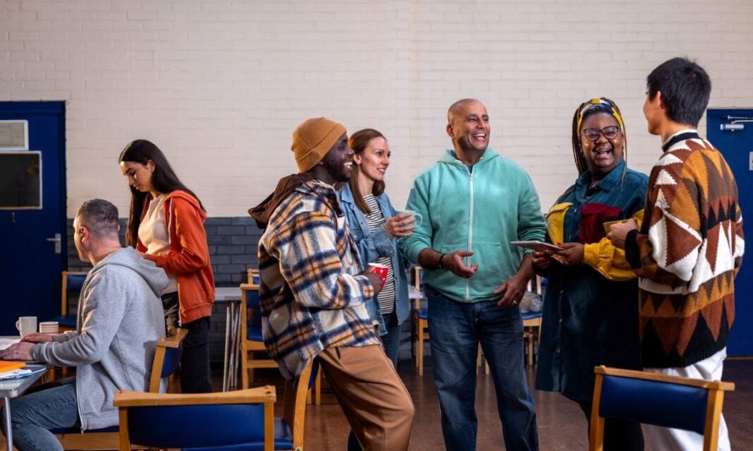 Detroit parents gather at a community center discussing local family support programs, childcare, housing and health resources.