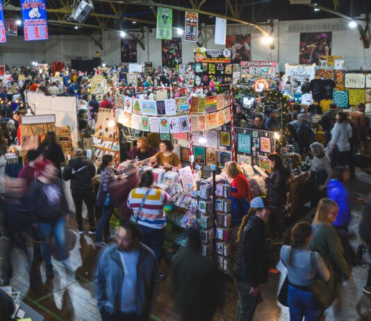 Shoppers browse handmade gifts at the Detroit Urban Craft Fair inside the Masonic Temple during the annual holiday market.