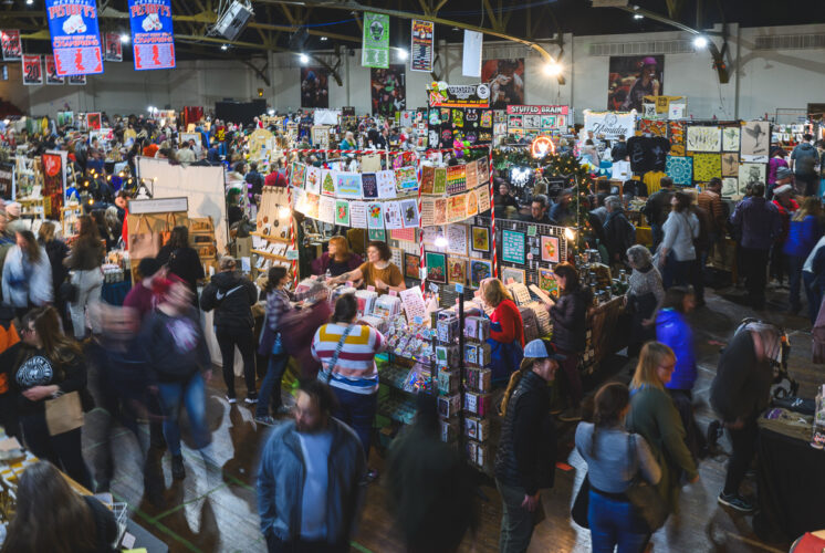Shoppers browse handmade gifts at the Detroit Urban Craft Fair inside the Masonic Temple during the annual holiday market.