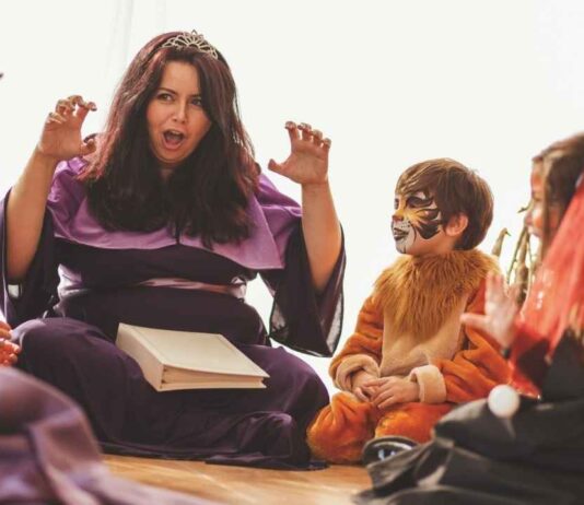 A performer entertains children in costume during the Fairytale Princess Celebration at Fairytale Fun Place with singing and storytelling.