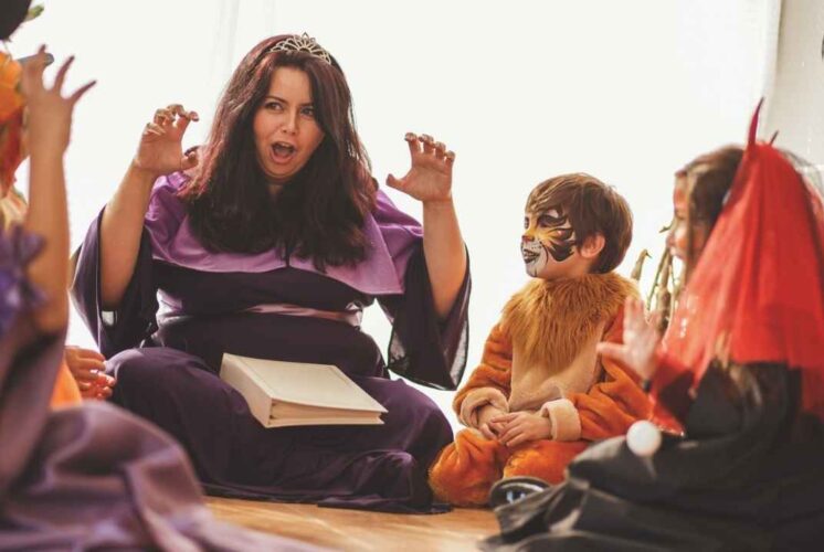 A performer entertains children in costume during the Fairytale Princess Celebration at Fairytale Fun Place with singing and storytelling.