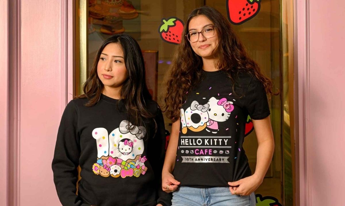 Two women wear Hello Kitty Cafe 10th anniversary shirts celebrating the Hello Kitty Cafe Truck visit to Twelve Oaks Mall in Novi.