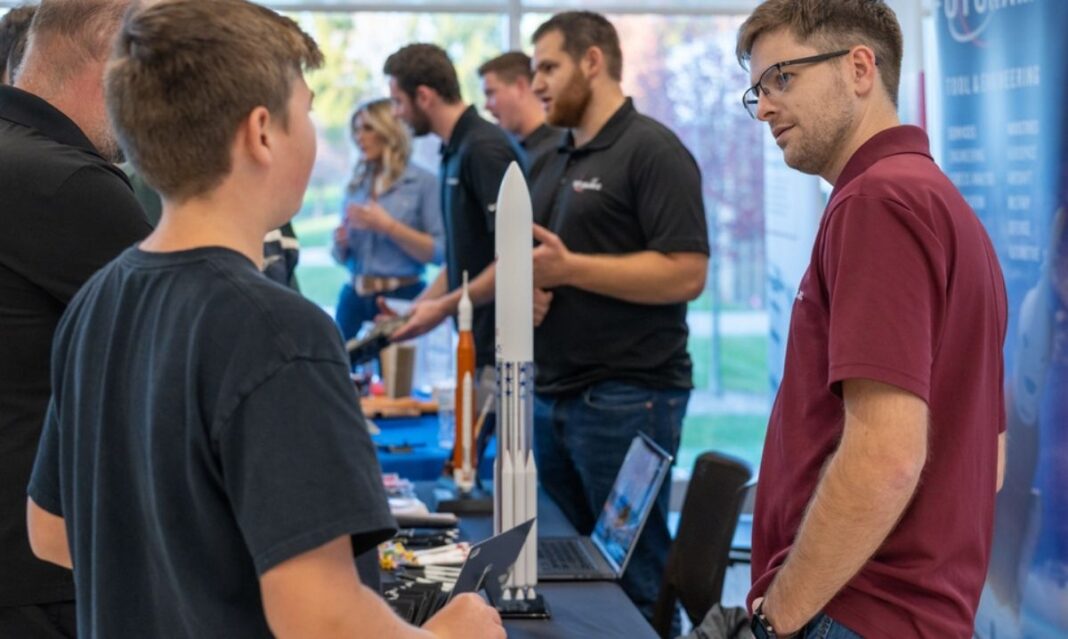 Student talking with a professional about engineering careers at the Innovate and Build event at Macomb Community College in Warren, Michigan.