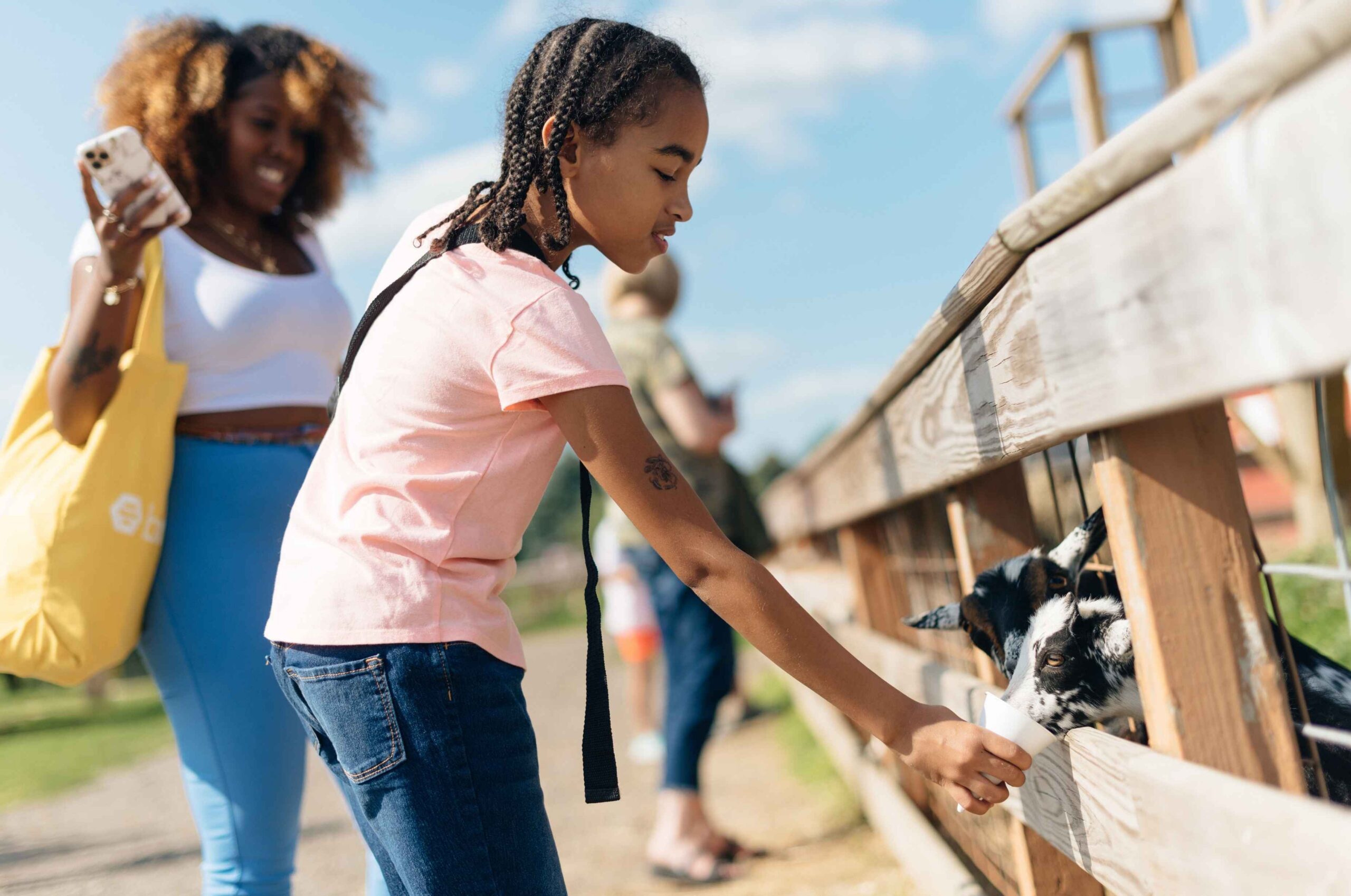 A child feeds goats at Blake’s Big Apple farm in metro Detroit during the Halloween season as families enjoy fall activities.